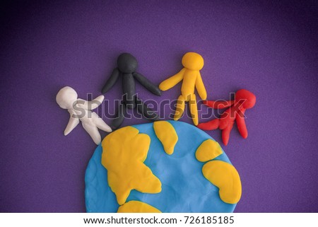 Group of people around the world. People and Earth are made out of play clay (plasticine).