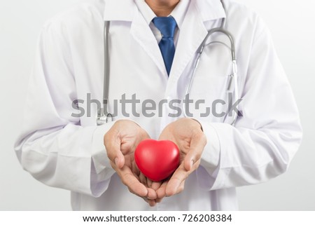 close up of doctor holds a red heart
