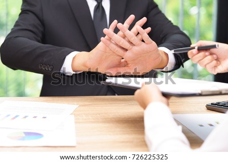 Businessman says no or hold on when businesswoman giving pen for signing a contract. Royalty-Free Stock Photo #726225325