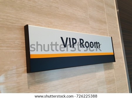 VIP room sign on wall in front of a room for special guests and important speaker at building office, Thailand. Business lounge concept. Angled view.