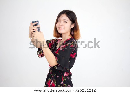 Portrait of thai adult beautiful girl short hair using her smart phone Selfie