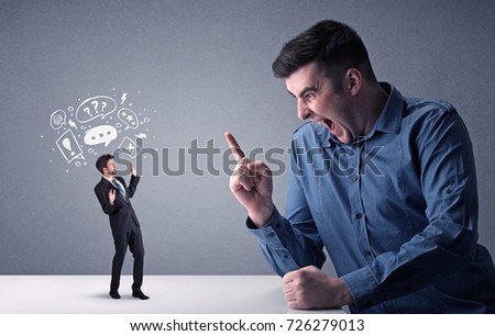 Young professional businessman being angry with an other miniature businessman who has drawn speech and thought bubbles above his head