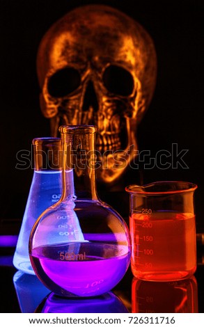 Halloween party fluorescent cocktail and skull. Isolated in black