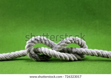 String knotted on a green background