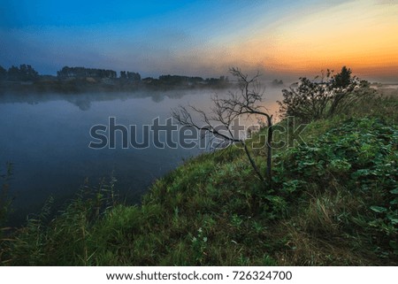Reflection of forest in the morning sunrise. Beautiful landscape in morning twilight time. Picture with copy space.
