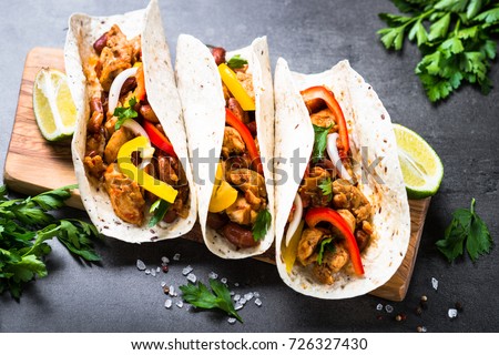 Mexican taco with meat beans and vegetables. Latin american food.