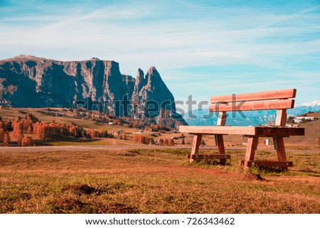Charming autumn landscape with a gigantic bench record in Alpe di Siusi, Italy, Dolomiti.  