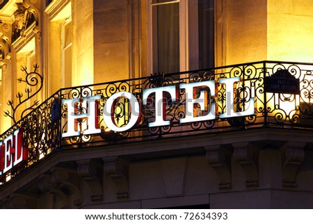 Illuminated hotel sign taken at dusk