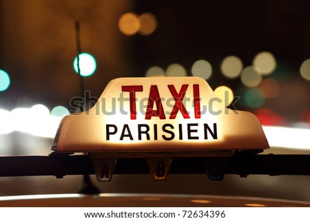 Parisian taxi, with the Arc de Triomphe and traffic light trails in the background