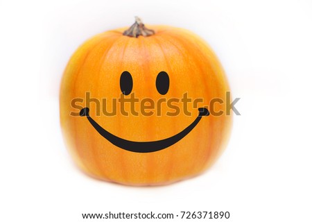 Funny pumpkin on a white background. The pumpkin has a drawn emoticon. Isolated. Anti Halloween
