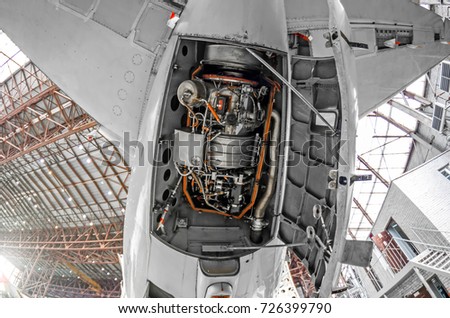 Auxiliary power plant in the tail of the aircraft with open hood covers Royalty-Free Stock Photo #726399790