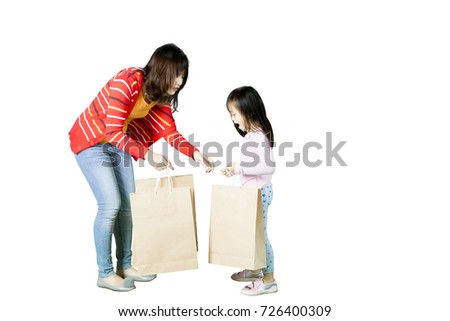 Picture of a pretty woman with her daughter holding shopping bags, isolated on white background