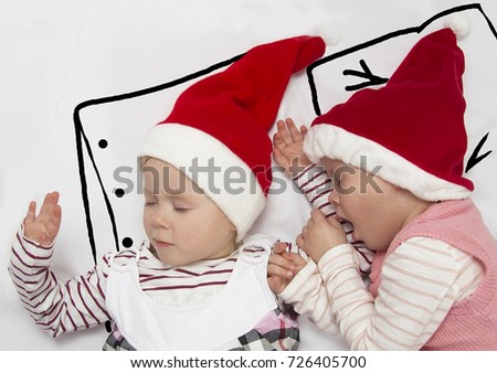 the children are sleeping in Santa's hats. in anticipation of Christmas