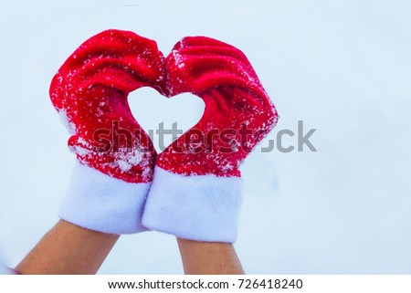 woman hands in winter gloves heart symbol shaped lifestyle and feelings concept, human making heart symbol with snowy hands in winter