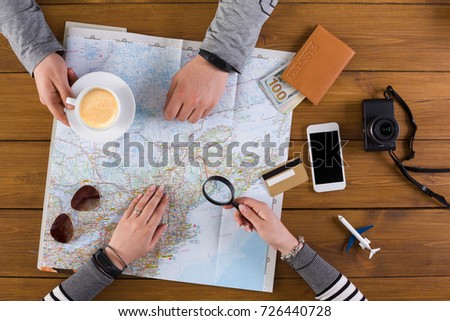 Couple planning travel. Searching for best route on map, preparation for summer vacation, top view