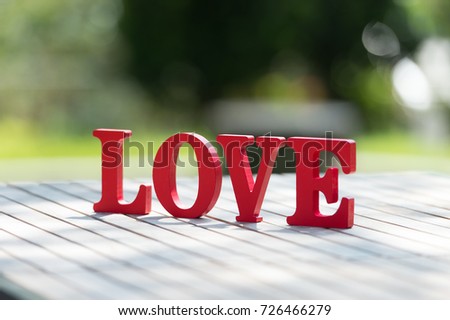 Wooden letters word "LOVE" with Wooden Letter L,O,V and E on wooden table, use for Valentine day background.