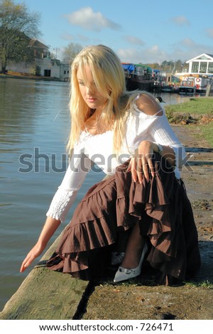 Young blonde woman by the river