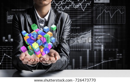 Cropped image of business woman in suit presenting multiple cubes in hands as symbol of innovations. Business sketches on background. 3D rendering.