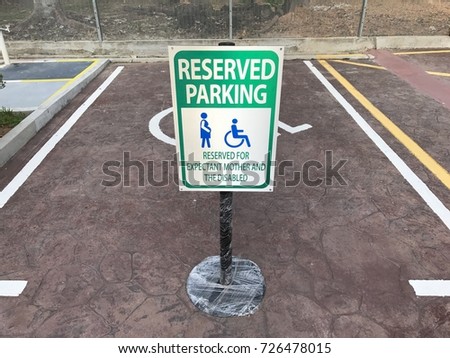 A signage showing priority or dedicated parking lot for pregnant woman and disabled person