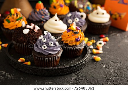 Festive Halloween cupcakes and treats decorated with sprinkles and candy