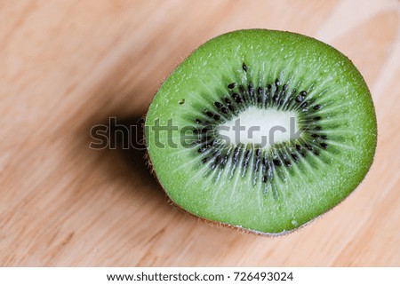 Beautiful background. Fresh kiwi fruit on wooden background with shadow
