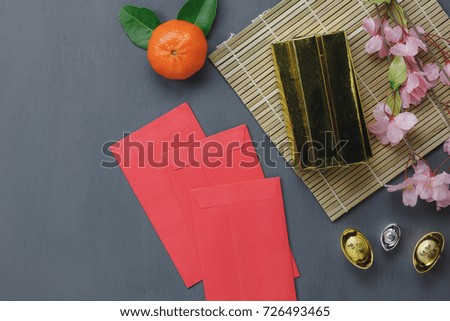 Top view of items for Chinese Happy New Year background.Different essential accessory on modern rustic table home decoration.Other language mean wealthy or rich and happiness.free space for creative.