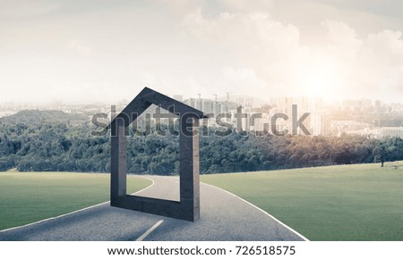 House stone figure as symbol of real estate outdoors against natural landscape