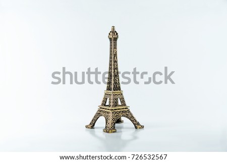 Little Eiffel tower on a white background. Jewel and accessory. The memory of the journey.