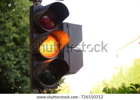 Yellow light of traffic lights in summer city Royalty-Free Stock Photo #726550312