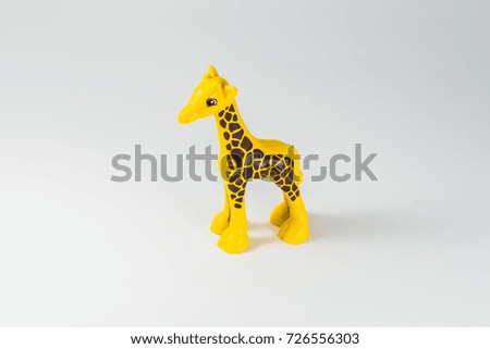 Plastic children's toy giraffe on a white background. Giraffe figurines.