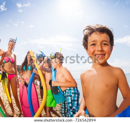 Portrait of a boy with friends on the beach