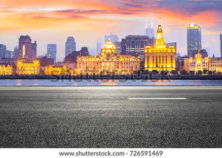 Asphalt road and modern cityscape in Shanghai at sunset
