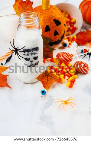 Halloween party set - drinks, candies and decor on white background. Copy space