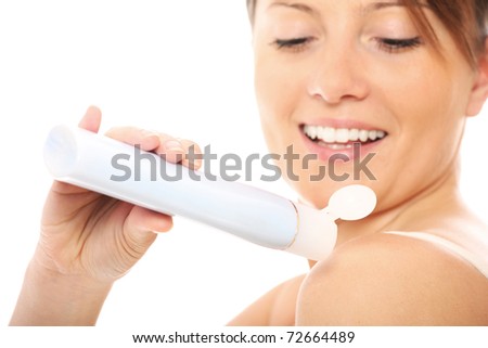 A picture of a beautiful woman using body cream over white background