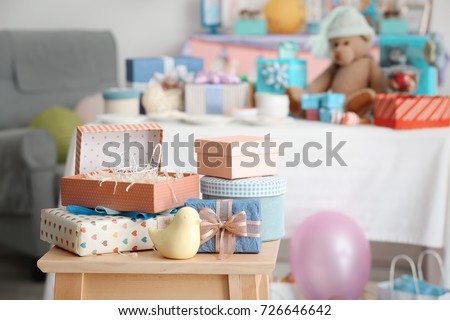 Gifts for baby shower on stool indoors Royalty-Free Stock Photo #726646642