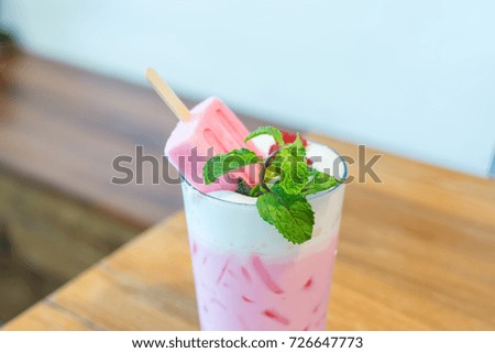 strawberry popsicle with pink milk in glass
