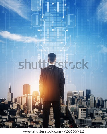 Back view of young businessman looking at city with abstract circuit board and sunlight. Future concept. Double exposure 