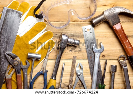 Assorted work tools on wooden board - DIY concept