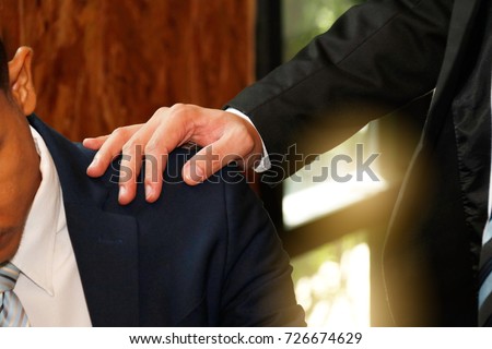 Businessmen encourage : Businessman smashing shoulders encouraging colleagues : Close up of male business man comforting colleagues with worries.

 Royalty-Free Stock Photo #726674629