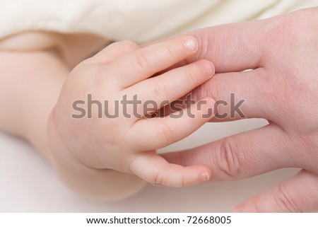 Mother's hand and baby in pastel shades - background