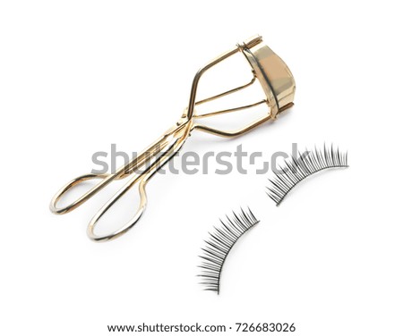 Curler and eyelashes, isolated on white