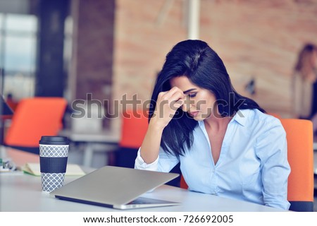 Young busy beautiful latin business woman suffering stress working at office computer Royalty-Free Stock Photo #726692005