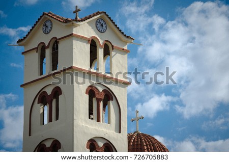 Neoi Pori in Pieria in Greece: detail of orthodox church with clock and clouds and blue sky 