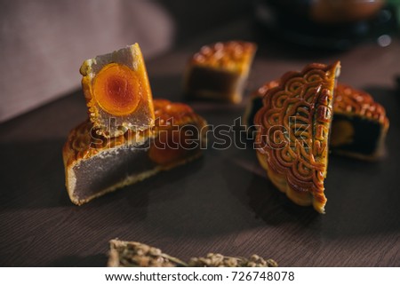 Beautiful Mooncakes and teacup on wooden table. Mid autumn festival Mooncakes in Vietnam. Royalty high quality free stock image.