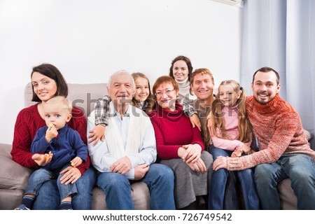 Family members making the family photo during a reunion party 