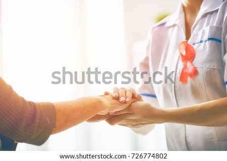 Pink ribbon for breast cancer awareness. Female patient listening to doctor in medical office. Support people living with tumor illness. Royalty-Free Stock Photo #726774802