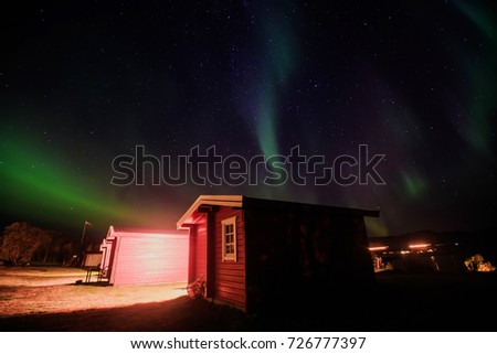 Beautiful picture of massive multicolored green vibrant Aurora Borealis, Aurora Polaris, also know as Northern Lights in the night sky over Norway, Scandinavia

