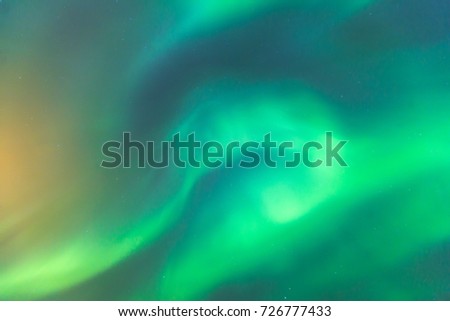 Beautiful picture of massive multicolored green vibrant Aurora Borealis, Aurora Polaris, also know as Northern Lights in the night sky over Norway, Scandinavia
