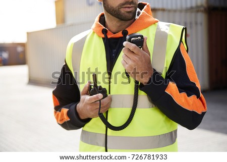 Docker with walkie talkie comms, close up Royalty-Free Stock Photo #726781933