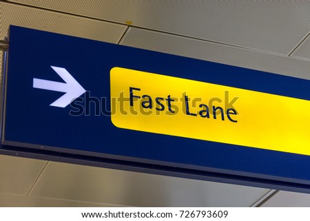 Fast Lane sign in blue and yellow at the airport close up
